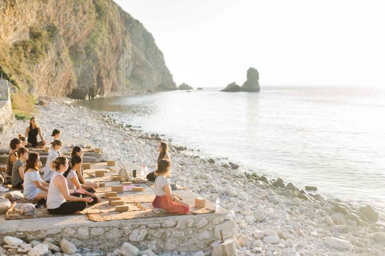 yoga meditation practice on the beach at our yoga retreat center in Montenegro, Europe